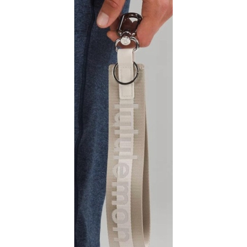 0269  NWT Lululemon Never Lost Keychain- Raw Linen/White Opal/White